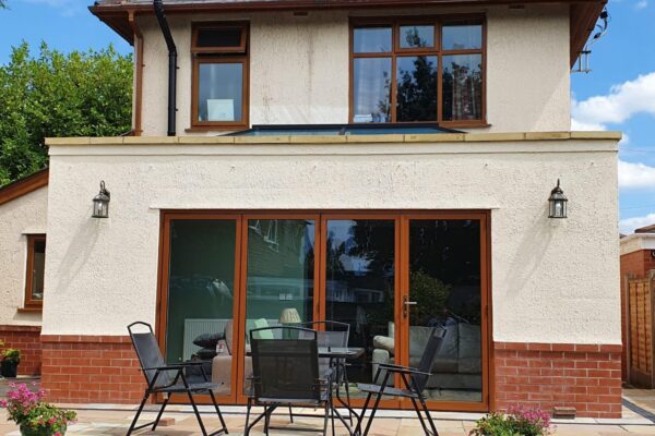 Garden-view-of-Orangery-constructed-in-Newton-Le-willows-with-Indian-stone-raised-patio-area-scaled-e1724149231458